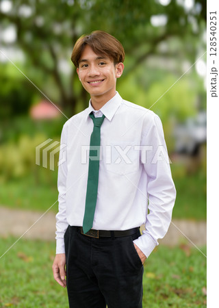 Non binary university student in college campus 128540251