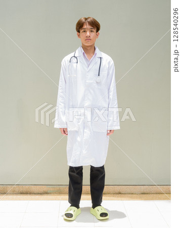 Young healthcare worker wearing lab coat full length portrait Young healthcare worker wearing lab coat full length portrait 128540296