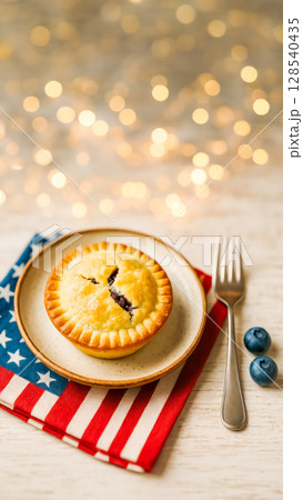 Mini Blueberry Pie On American Flag Napkin For Fourth Of July Celebration. Concept of Patriotic Food Styling, Independence Day Decor, Summer Festivities, And Americana-Themed Holiday Visuals 128540435