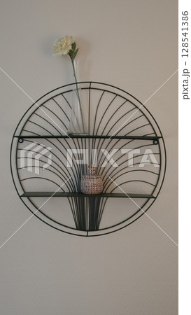 Wall mounted decorative shelf with minimalist design and modern decor elements showcasing a flower vase Wall mounted decorative shelf with minimalist design and modern decor elements showcasing a flower vase 128541386