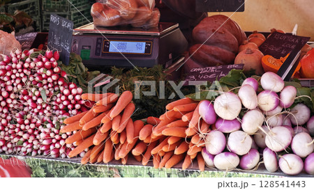 Vibrant market display of fresh vegetables with a variety of colors and textures showcasing local produce during a sunny afternoon 128541443