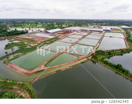 The aerial view of many ponds and paths near the manufactory shot by drone. 128542343