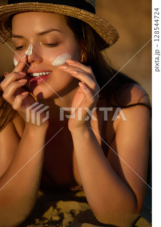 Woman is applying a facial sunscreen product. Cream, moisturizer and facial woman in skincare, beauty or cosmetics. Face daily care routine. Woman is applying a facial sunscreen product. Cream, moisturizer and facial woman in skincare, beauty or cosmetics. Face daily care routine. 128544724