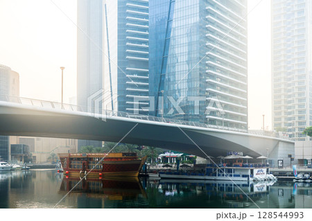 Dubai, UAE - September 29, 2024 Dawn in Dubai Marina, yachts and ships parked in calm blue water. Editorial Dubai, UAE - September 29, 2024 Dawn in Dubai Marina, yachts and ships parked in calm blue water. Editorial 128544993
