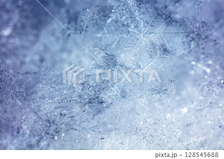Macro snowflakes showing intricate winter details on dark background 128545688