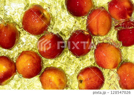 Whole Ripe Peaches in Water. Top View with Ripples and Splash. Whole Ripe Peaches in Water. Top View with Ripples and Splash. 128547026