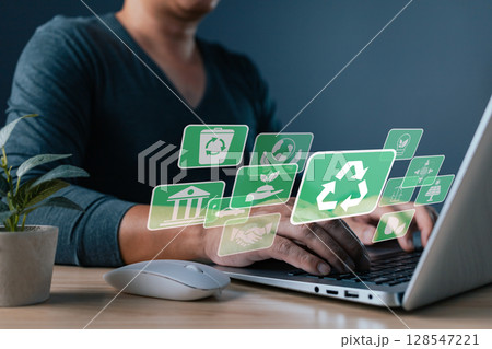 A person uses software to save energy and promote a sustainable environment, supporting ESG principles, green business innovation, and climate friendly development. A person uses software to save energy and promote a sustainable environment, supporting ESG principles, green business innovation, and climate friendly development. 128547221