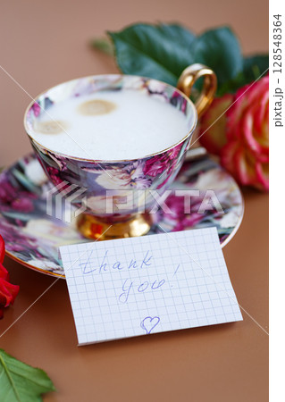 Morning break, roses decorate a card with gratitude 128548364