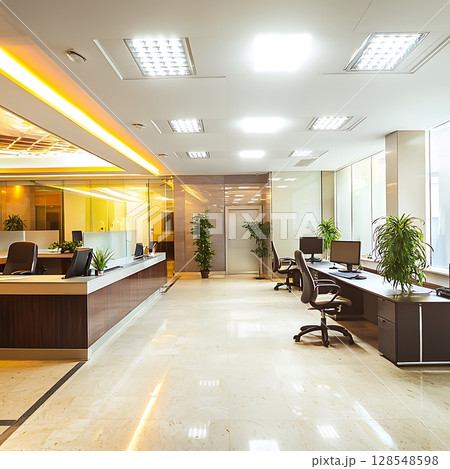 A large open office space with a lot of natural light and plants A large open office space with a lot of natural light and plants 128548598