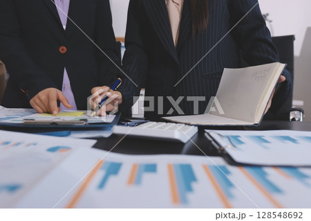 Team of business people working together in the meeting room office,teamwork background charts and graphs banner, double exposure successful teamwork,business planning concept. 128548692