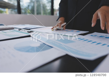 Team of business people working together in the meeting room office,teamwork background charts and graphs banner, double exposure successful teamwork,business planning concept. 128548700
