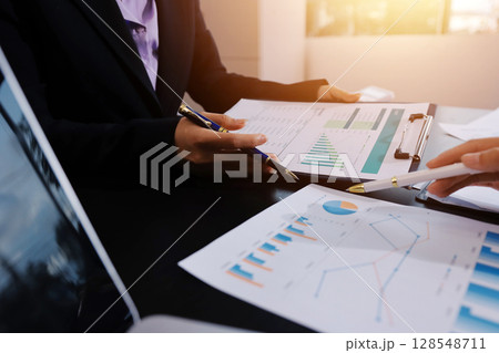 Team of business people working together in the meeting room office,teamwork background charts and graphs banner, double exposure successful teamwork,business planning concept. 128548711