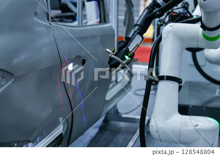 3D scanner on robotic arm measure the accuracy of automotive parts. in industrial plants 128548804