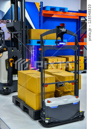 Autonomous Cargo transport robot in warehouses automation or Robots in storage hangar for moving racks, Warehouse automation concept. 128548810