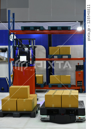 Autonomous Cargo transport robot in warehouses automation or Robots in storage hangar for moving racks, Warehouse automation concept. Autonomous Cargo transport robot in warehouses automation or Robots in storage hangar for moving racks, Warehouse automation concept. 128548811