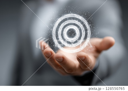 Businessman presents virtual target board in a modern business environment Businessman presents virtual target board in a modern business environment 128550765
