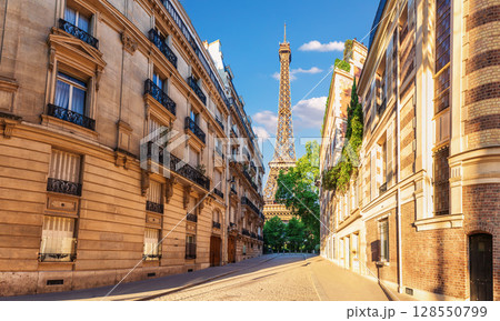 Eiffel Tower, famous landmark of Paris, view from a typical street of France 128550799
