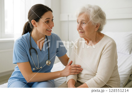 Young nurse caring for elderly patient woman in hospital room. concept of healthcare, compassionate support, medical care 128551214