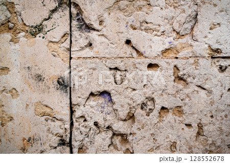 Old stone wall with cracks and scratches. Abstract background and texture for design. Old stone wall with cracks and scratches. Abstract background and texture for design. 128552678