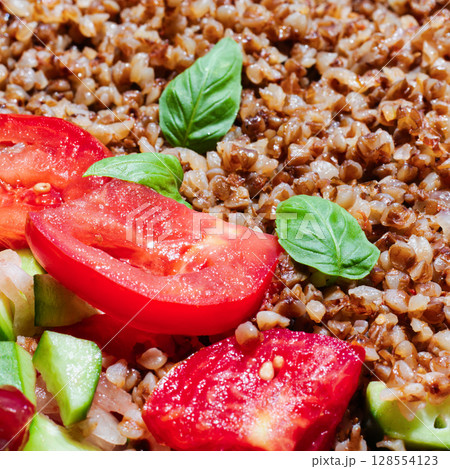 Healthy food without meat with buckwheat and a salad of chopped tomatoes, cucumbers, onions and basil leaves. The photo is suitable for the topic of healthy lifestyle and healthy eating Healthy food without meat with buckwheat and a salad of chopped tomatoes, cucumbers, onions and basil leaves. The photo is suitable for the topic of healthy lifestyle and healthy eating 128554123