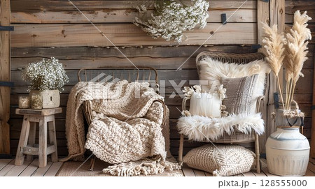 Inside the wooden room are a chair, blankets, pillows, and flowers 128555000
