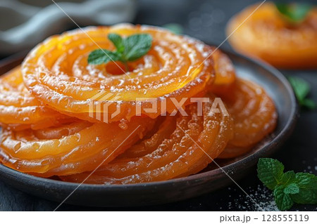 A plate of food on a table with a mint leaf placed on top 128555119