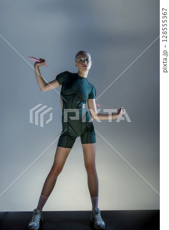 athletic girl holds rackets for bambinton athletic girl holds rackets for bambinton 128555367