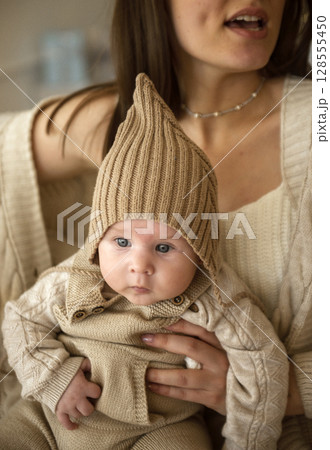 A woman holding a baby A woman holding a baby 128555450