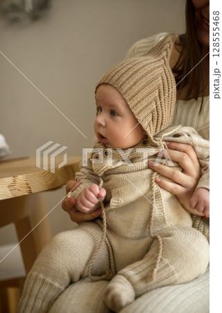 A woman holding a baby A woman holding a baby 128555468