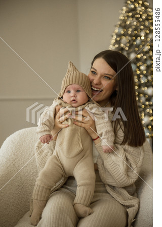 A woman holding a baby 128555486