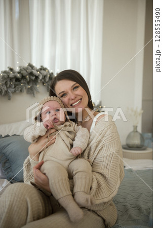 A baby wearing a hat 128555490