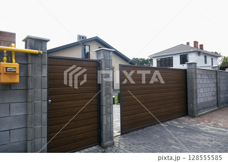 gate to the courtyard of the house. the gate is brown. 128555585