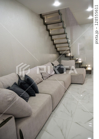 Living room. Light. There is a large sofa in the living room. 128555611
