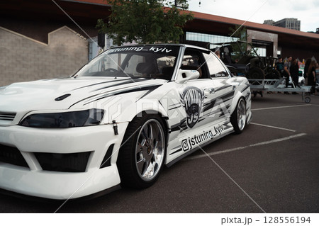 A modified hatchback car with performance or racing modifications 128556194