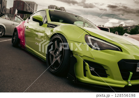 KYIV, UKRAINE - JUNE 8, 2024: Modified striking two-tone pink and lime green job Subaru BRZ KYIV, UKRAINE - JUNE 8, 2024: Modified striking two-tone pink and lime green job Subaru BRZ 128556198