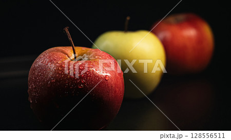 Three Apples in a Row on Black Background - Minimalist Fruit Composition Three Apples in a Row on Black Background - Minimalist Fruit Composition 128556511