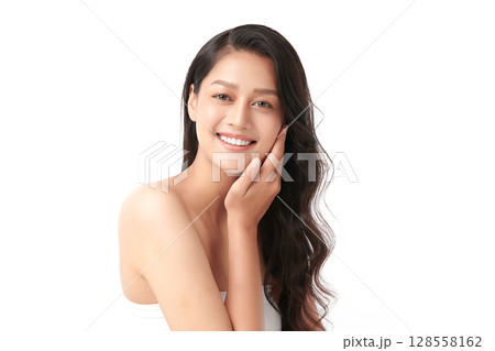 A beautiful young Asian woman with clean, fresh skin against a white background. Skincare, facial treatment, cosmetology, beauty, and spa. An elegant portrait of an Asian woman. A beautiful young Asian woman with clean, fresh skin against a white background. Skincare, facial treatment, cosmetology, beauty, and spa. An elegant portrait of an Asian woman. 128558162