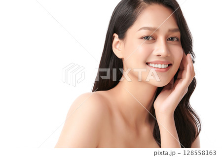 A beautiful young Asian woman with clean, fresh skin against a white background. Skincare, facial treatment, cosmetology, beauty, and spa. An elegant portrait of an Asian woman. 128558163