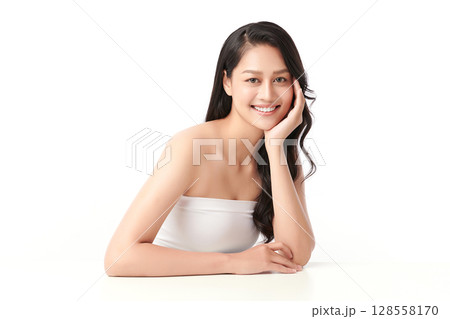 A beautiful young Asian woman with clean, fresh skin against a white background. Skincare, facial treatment, cosmetology, beauty, and spa. An elegant portrait of an Asian woman. 128558170
