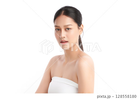 A beautiful young Asian woman with clean, fresh skin against a white background. Skincare, facial treatment, cosmetology, beauty, and spa. An elegant portrait of an Asian woman. 128558180