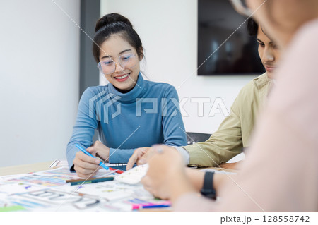 Creative Team Collaborating on UX UI Design Project in Modern Office Environment Creative Team Collaborating on UX UI Design Project in Modern Office Environment 128558742