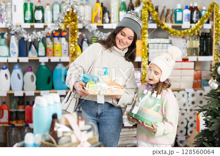 Woman with child family select and studies label present, consist of bathroom cosmetics on X mas Eve Woman with child family select and studies label present, consist of bathroom cosmetics on X mas Eve 128560064