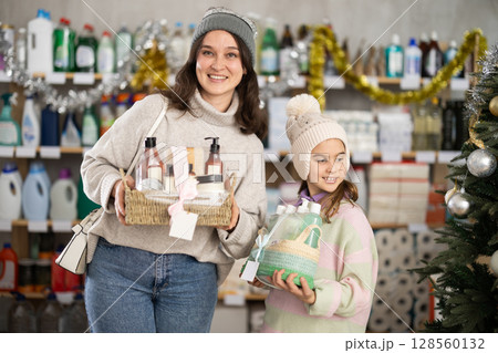 Mom and daughter shopping for Christmas presents together at home goods store Mom and daughter shopping for Christmas presents together at home goods store 128560132