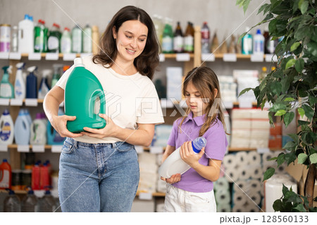 woman with a child chooses a detergent woman with a child chooses a detergent 128560133