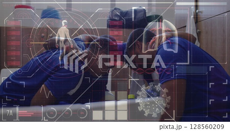 Digital interface with data processing against team of male soccer players making a huddle Digital interface with data processing against team of male soccer players making a huddle 128560209