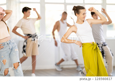 Teenage girl dancing jazz funk in group Teenage girl dancing jazz funk in group 128560817