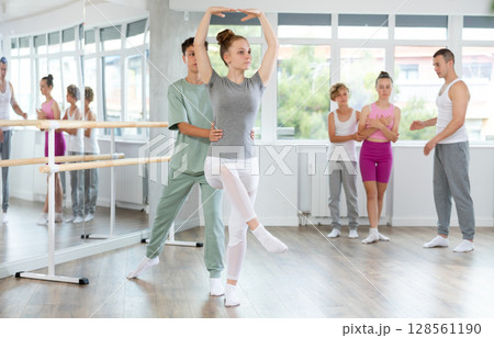Boy and girl in pair train to perform ballet dance during rehearsal in studio 128561190