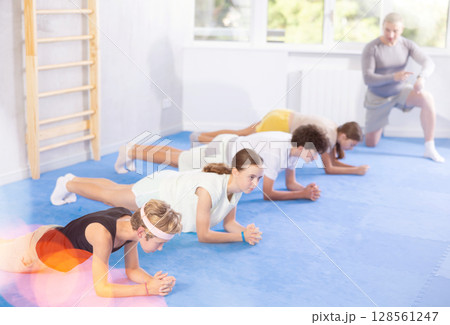 Group of children doing abdominal exercises 128561247