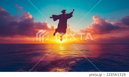 Joyful Graduate Leaping Over Ocean at Sunset, Celebrating Achiev 128561326
