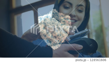 Image of network of connections with security shield over people using payment terminal 128561606